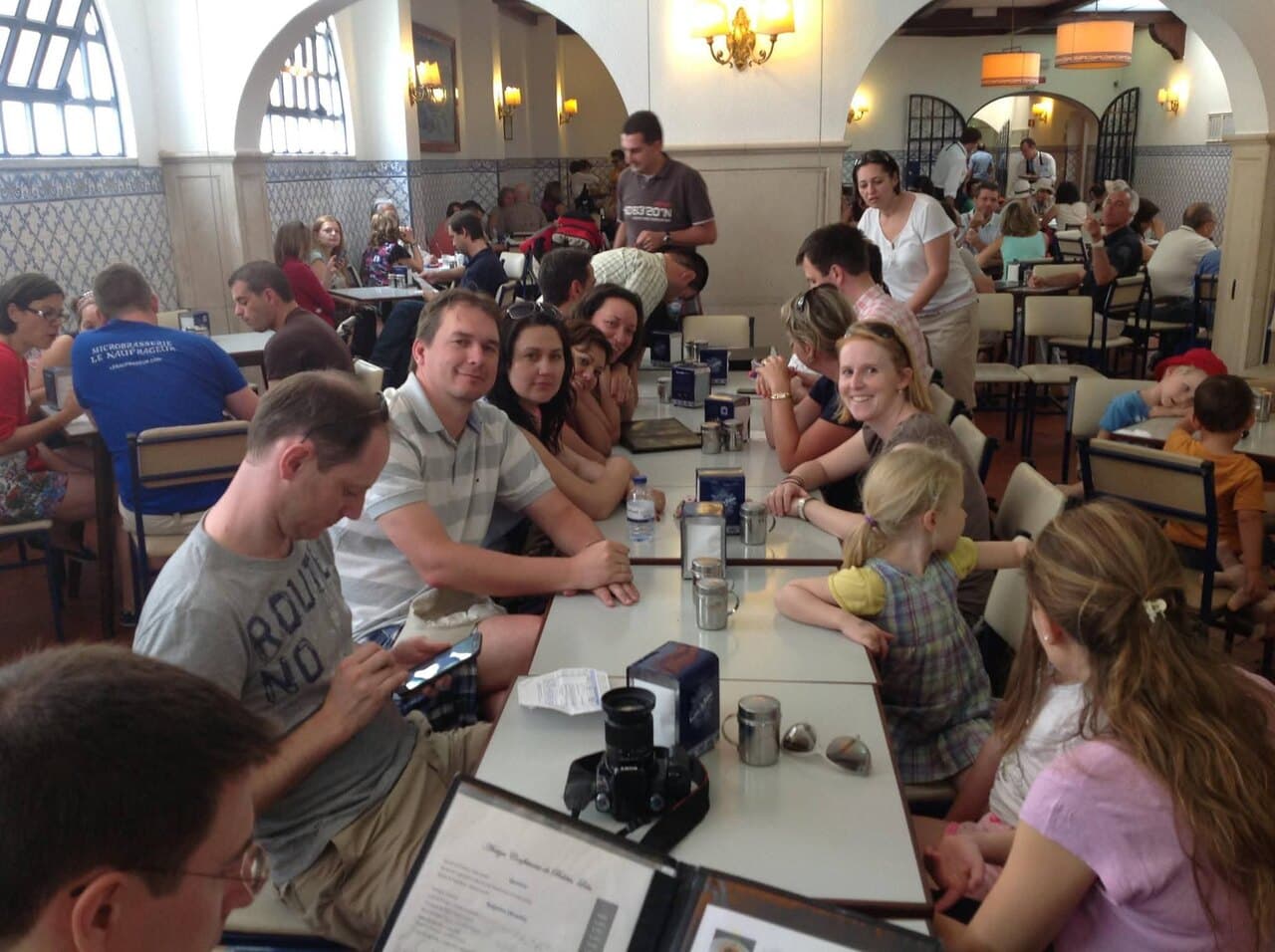 A long table of us in a tiled café in Lisbon