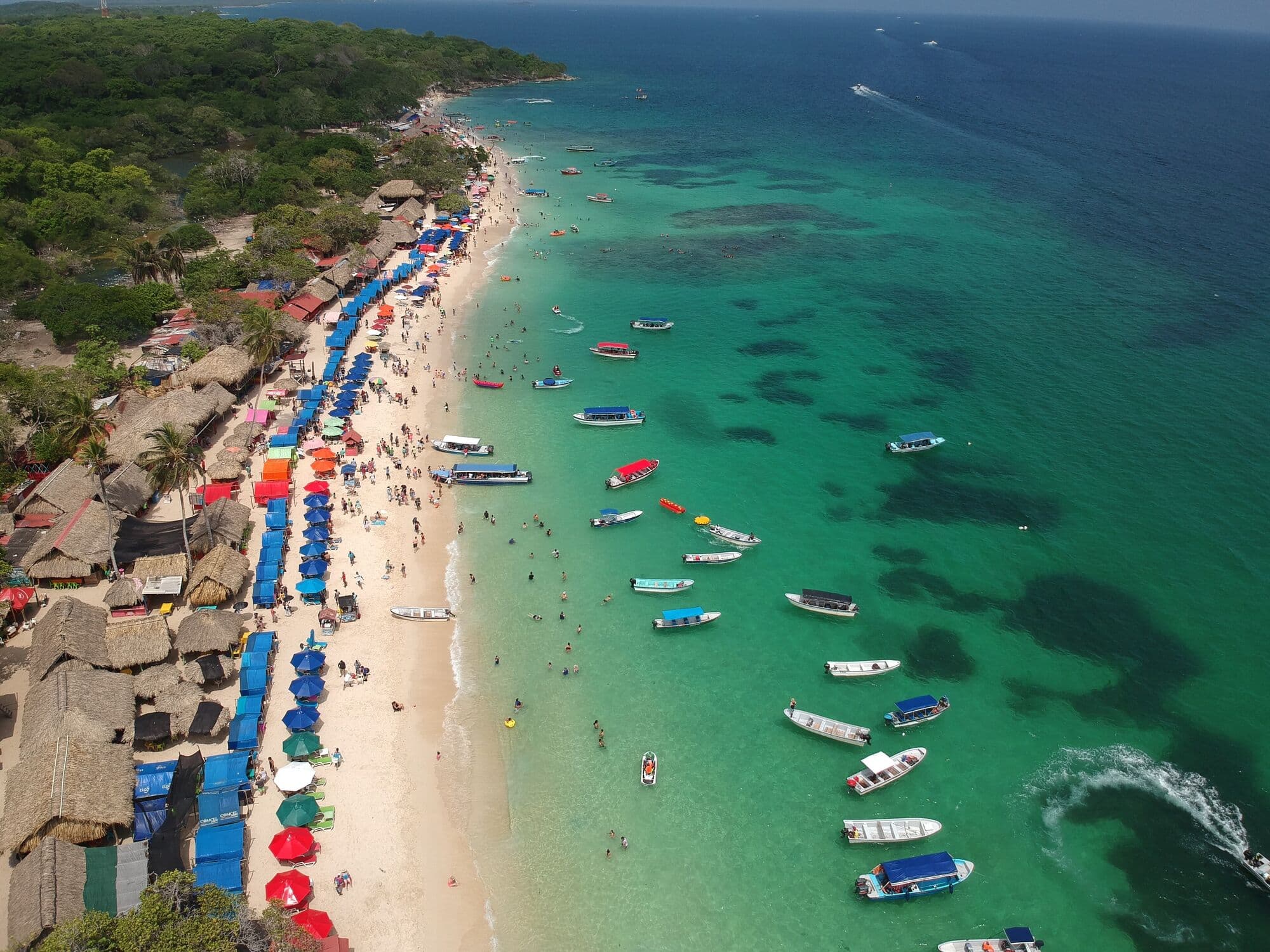 Playa Blanca from the air: white sand, palm-thatched huts and turquoise water