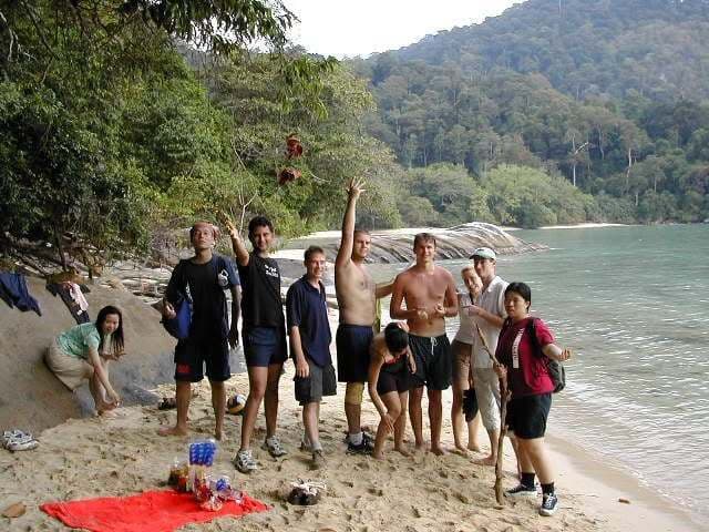A gang of us on a Tioman beach with the jungle behind
