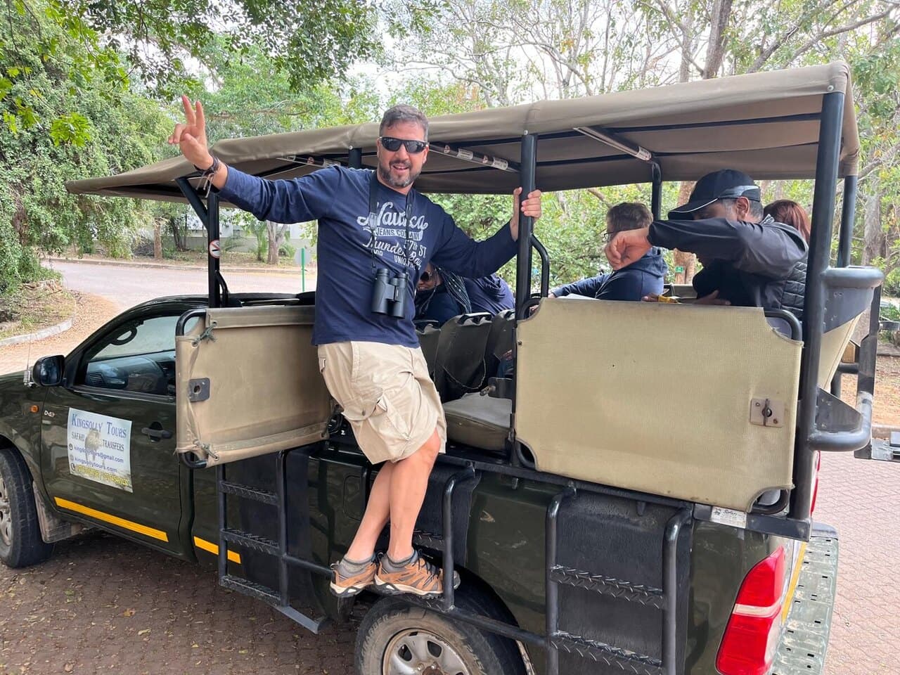 One of us waving from the back of a safari truck
