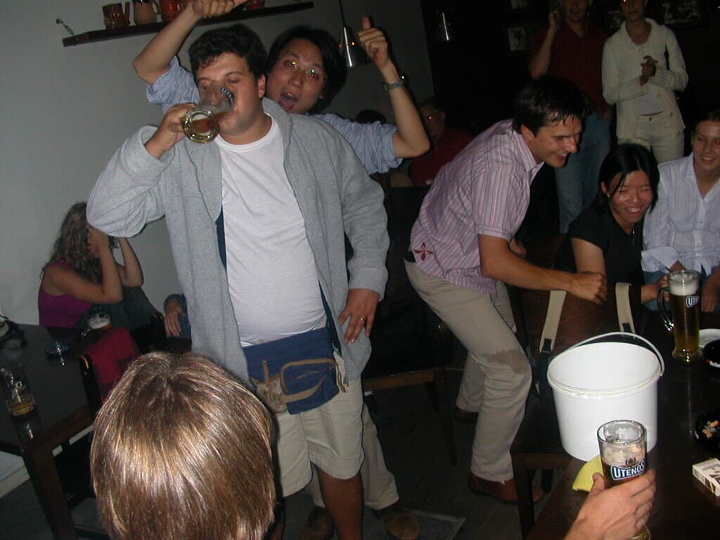 A night out in a bar, one of us downing a beer while the others cheer him on