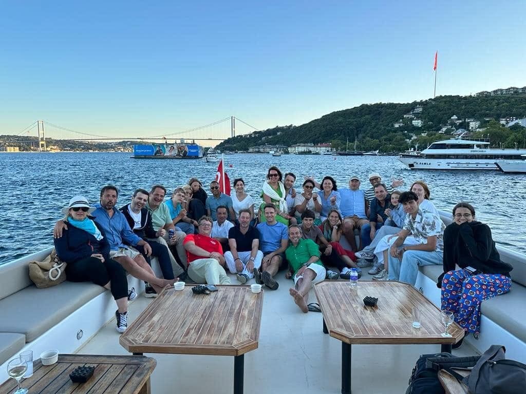 The whole group on the deck of a boat on the Bosphorus, with the bridge behind
